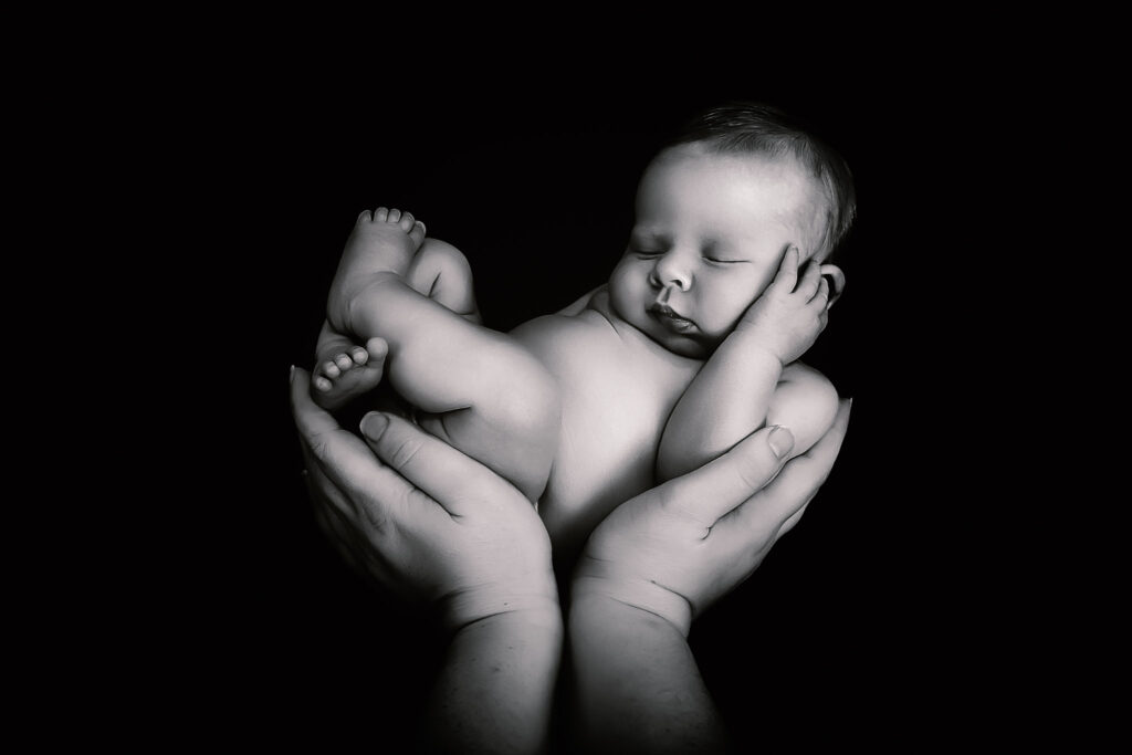 Newborn Photography. Baby in hands.